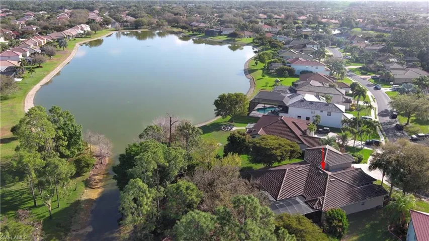Aerial view of residential area featuring a nearby body of water