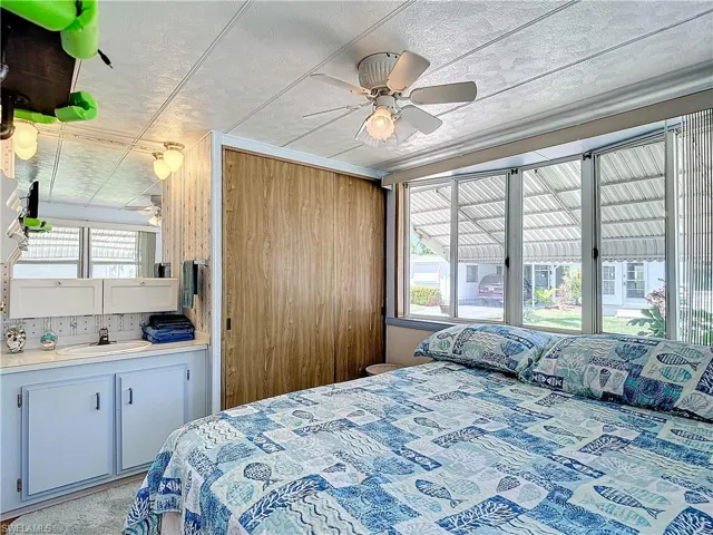 Bedroom featuring ceiling fan and sink
