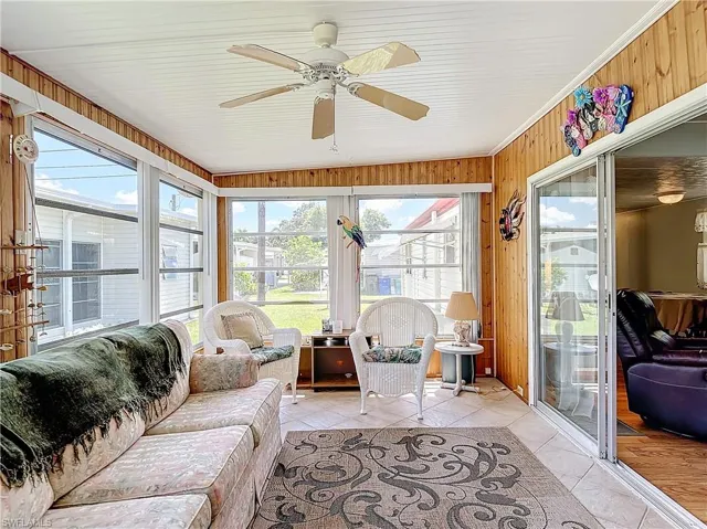 Sunroom / solarium with a healthy amount of sunlight, ceiling fan, and vaulted ceiling