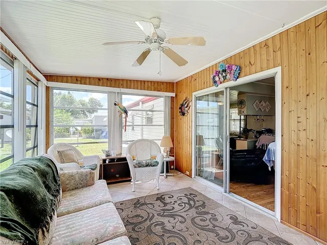 Sunroom / solarium featuring ceiling fan