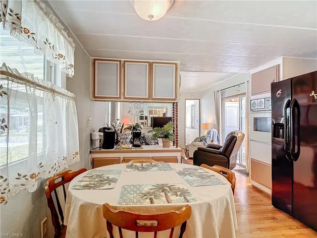 Dining space with light hardwood / wood-style flooring