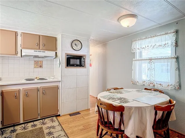 Dining room featuring a textured ceiling and light wood-type flooring