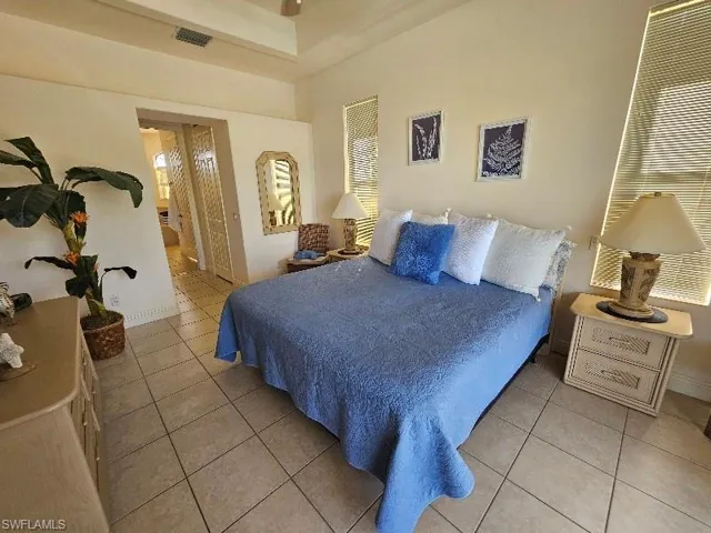 Bedroom with light tile patterned floors and a closet