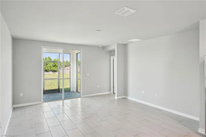 Spare room featuring baseboards and visible vents