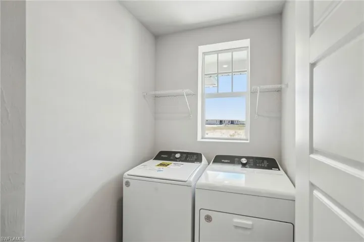 Laundry room featuring washer and dryer and laundry area