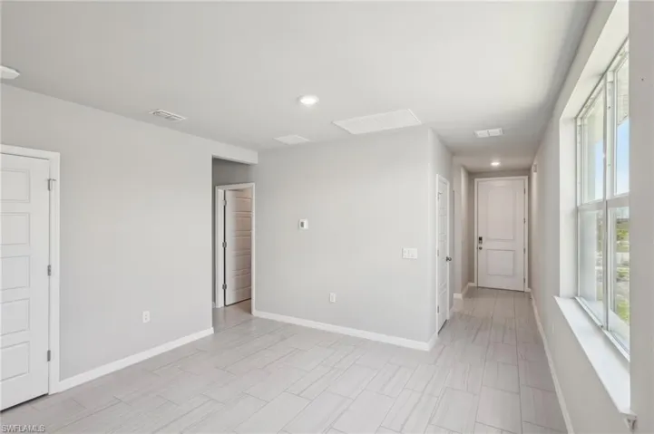 Spare room featuring recessed lighting, visible vents, and baseboards
