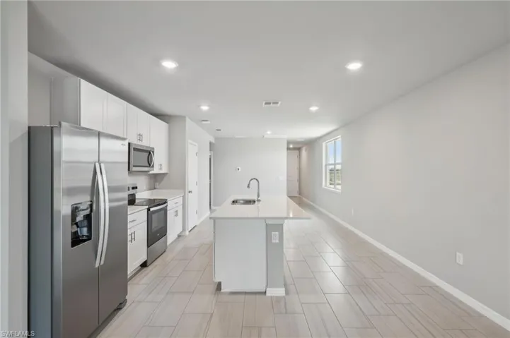 Kitchen featuring a sink, visible vents, white cabinets, and appliances with stainless steel finishes