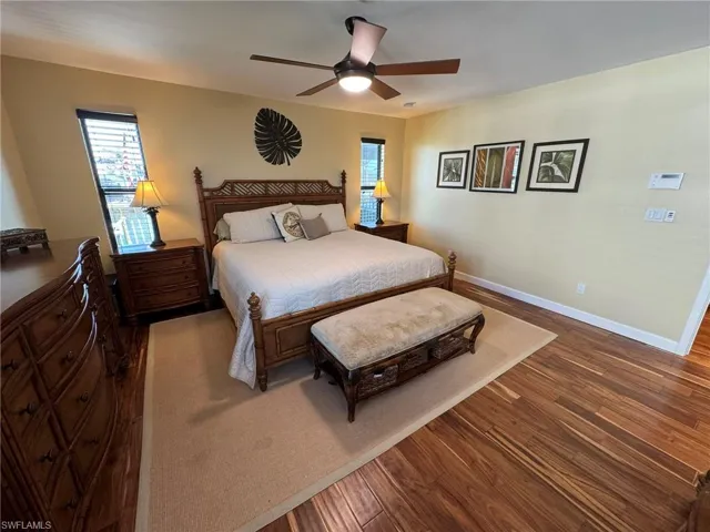 MASTER Bedroom featuring multiple windows, hardwood / wood-style floors, and ceiling fan