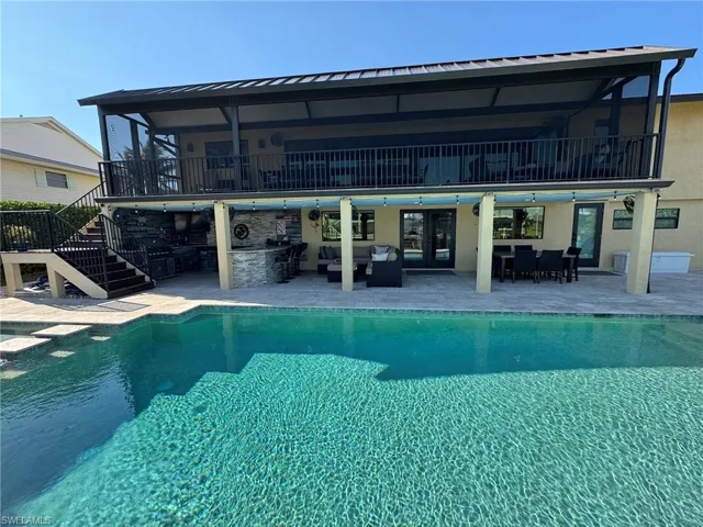 View of pool with an outdoor living space and a patio area