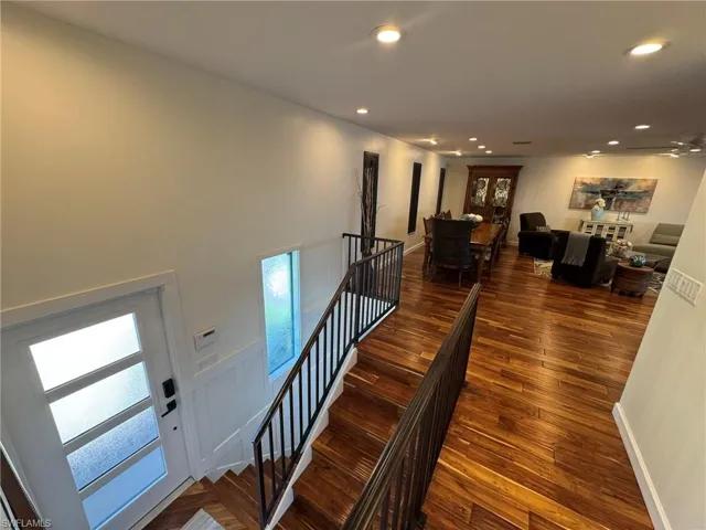 Stairs with hardwood / wood-style floors
