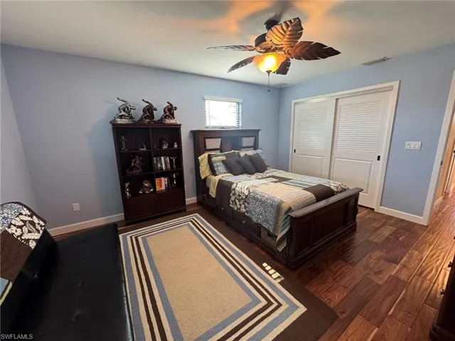 2ND UPSTAIRS Bedroom with a closet, dark hardwood / wood-style floors, and ceiling fan