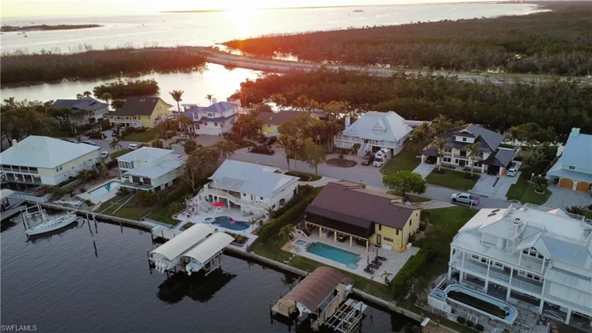 Aerial view at dusk featuring a water view