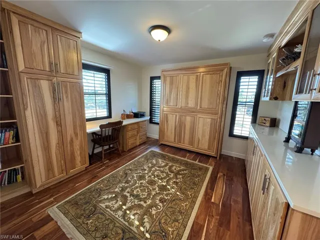 Office/3RD BEDROOM area featuring dark hardwood / wood-style floors and built in desk