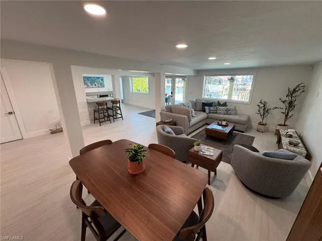 DOWNSTAIRS Living room featuring light hardwood / wood-style flooring and a textured ceiling