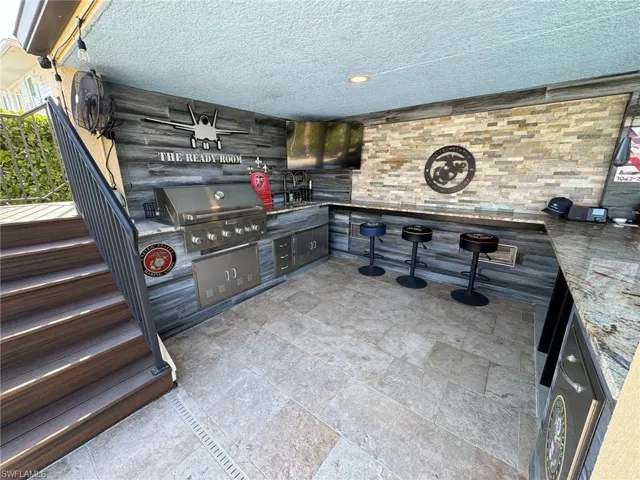 View of patio with grilling area and an outdoor kitchen