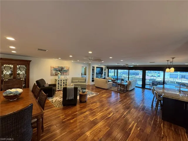 Living room featuring sink and dark hardwood / wood-style flooring