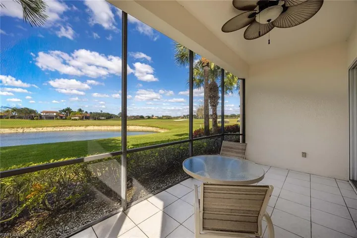 Sunroom / solarium with a water view and ceiling fan