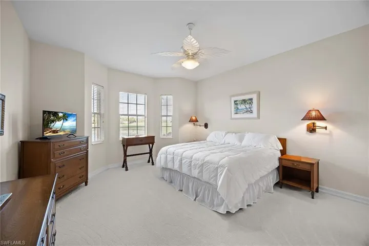 Bedroom featuring light colored carpet and ceiling fan