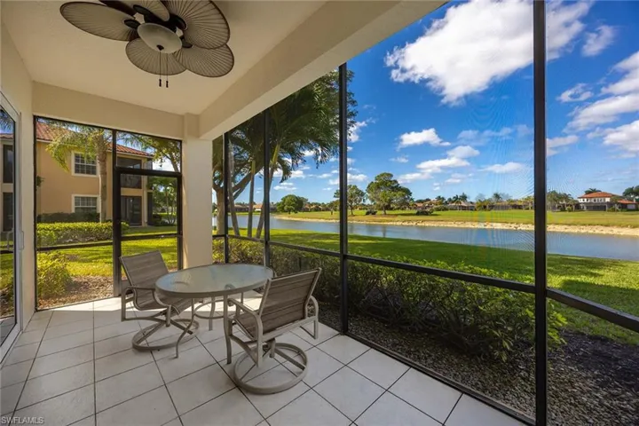 Sunroom with a water view, ceiling fan, and outdoor dining area