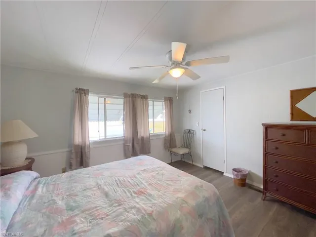 Bedroom featuring ceiling fan and dark hardwood / wood-style flooring