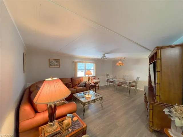 Living room featuring ceiling fan and hardwood / wood-style flooring