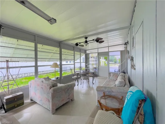Sunroom featuring ceiling fan