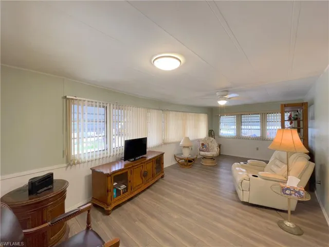 Living room featuring ceiling fan, hardwood / wood-style floors, and a wealth of natural light