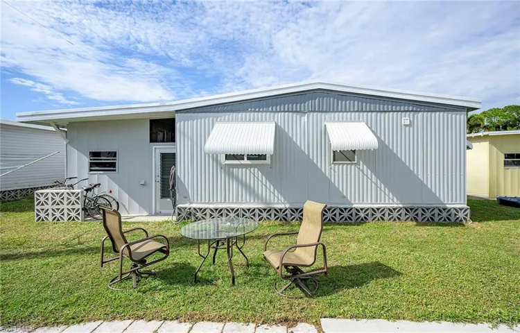 Back of property featuring a yard