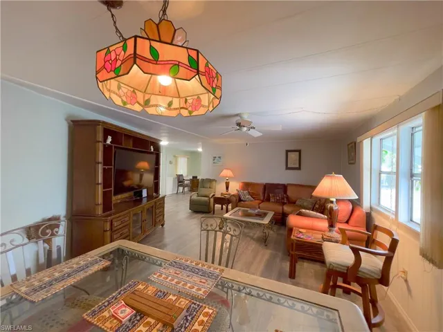 Living room featuring ceiling fan and hardwood / wood-style flooring