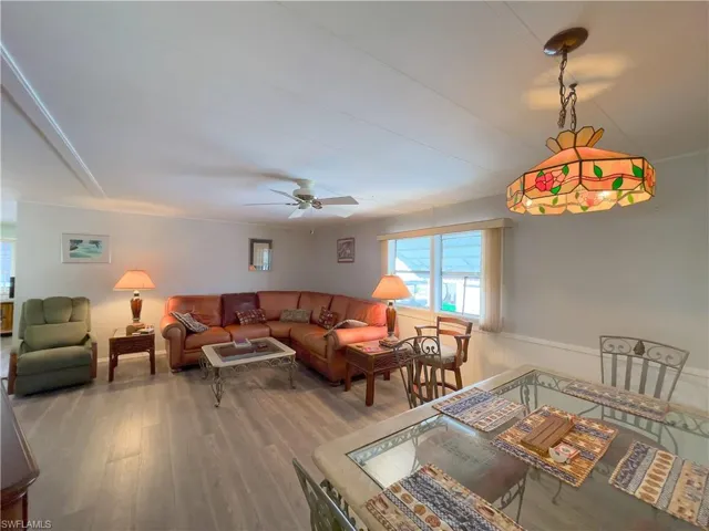 Living room with ceiling fan and wood-type flooring