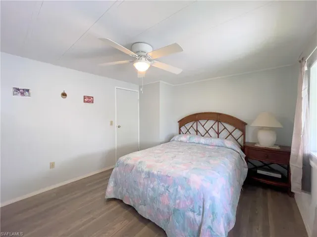 Bedroom with ceiling fan and dark hardwood / wood-style flooring
