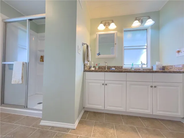 Bathroom with an enclosed shower and vanity