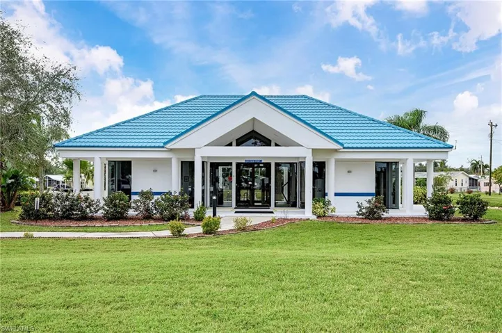 Back of property featuring a lawn