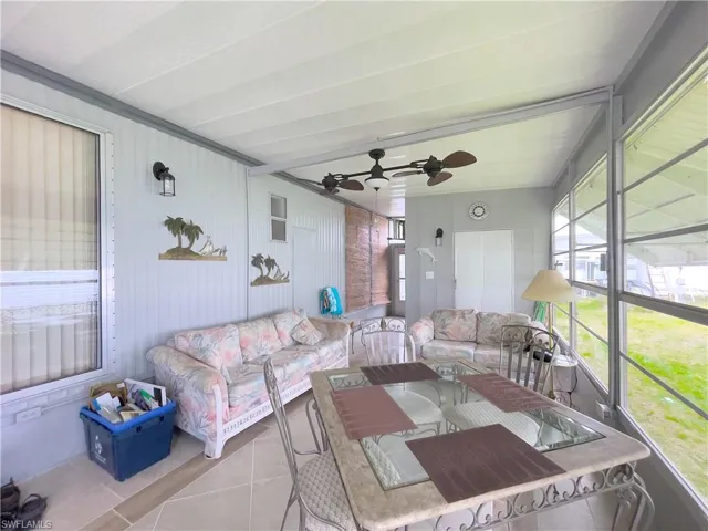 Sunroom featuring ceiling fan