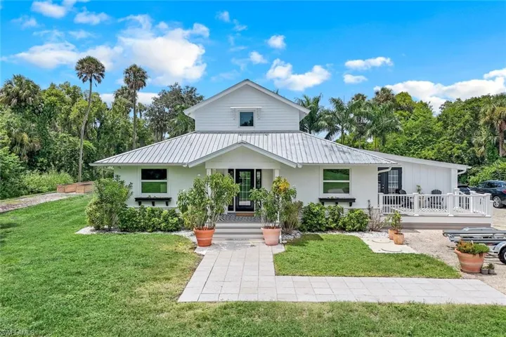 View of front of home featuring a front yard and a porch