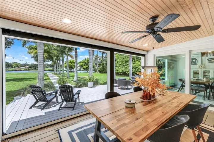 Sunroom featuring wood ceiling and ceiling fan