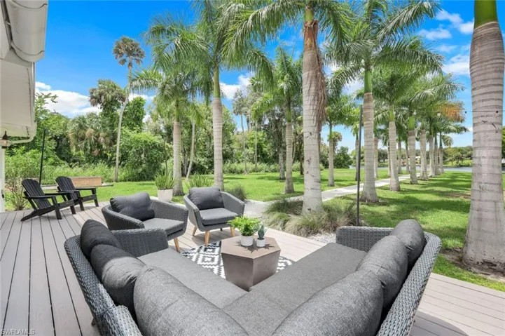 Wooden deck with outdoor lounge area and a lawn