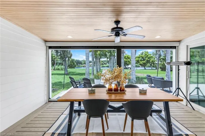 Sunroom with a wealth of natural light, ceiling fan, and wooden ceiling