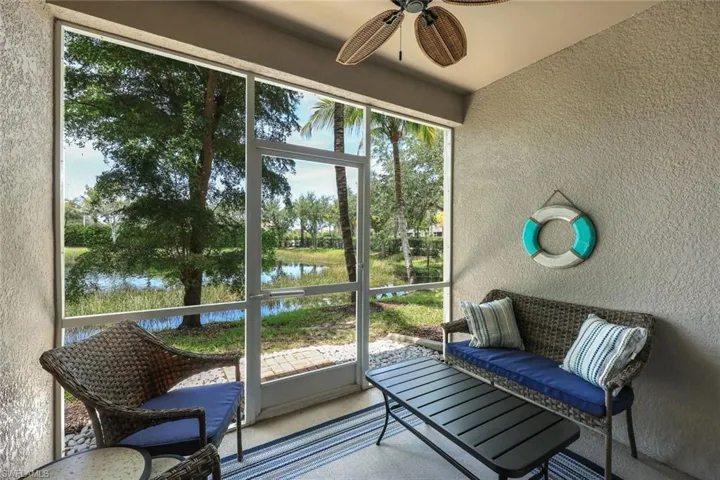 Sunroom featuring a water view, ceiling fan, and lofted ceiling