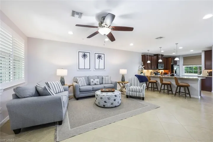 Tiled living room featuring ceiling fan