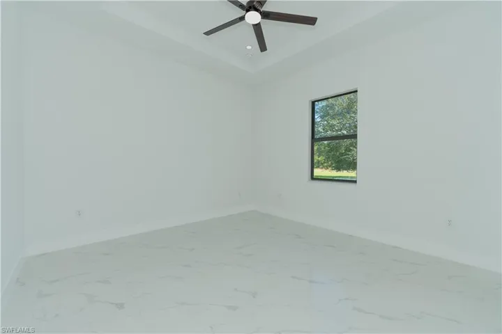 Spare room featuring ceiling fan and a raised ceiling