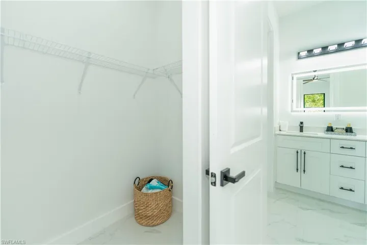 Walk in closet featuring sink and ceiling fan