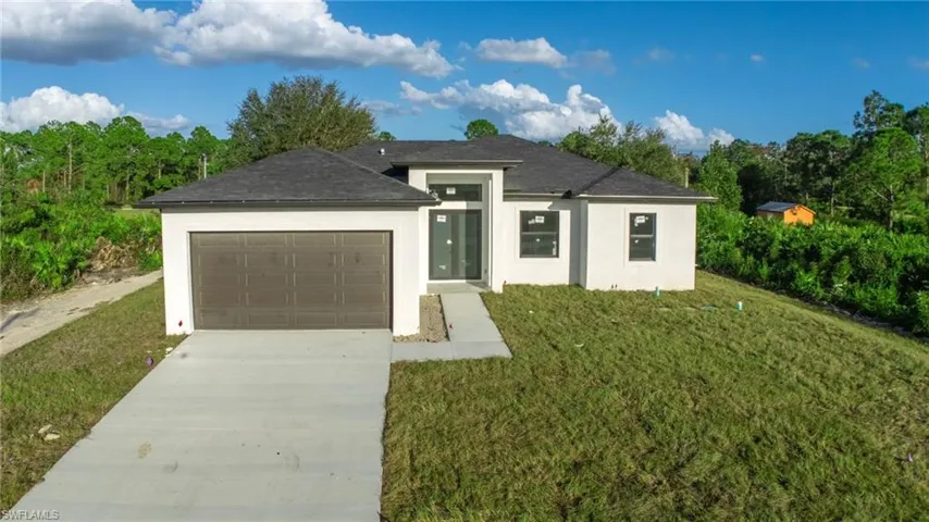 View of front of house with a front lawn and a garage