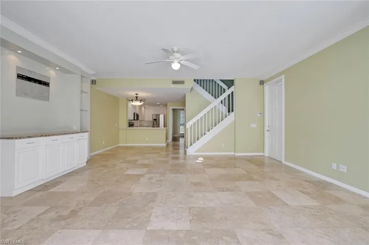 Unfurnished room with ceiling fan and crown molding