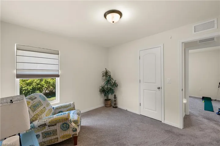Living area with light colored carpet
