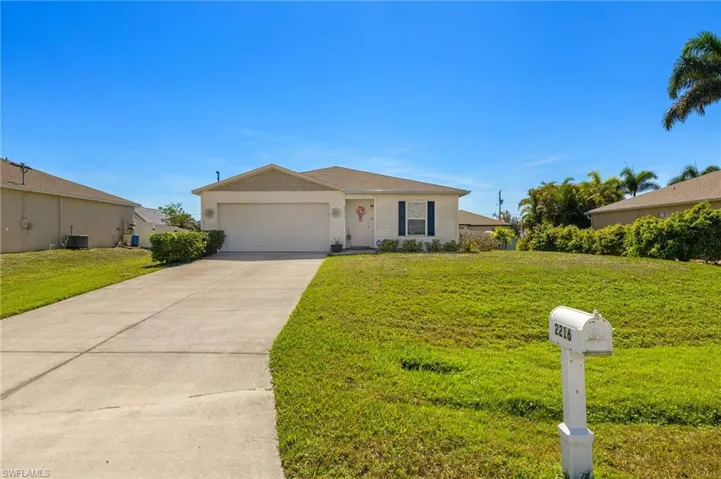 Single story home featuring a front lawn and a garage