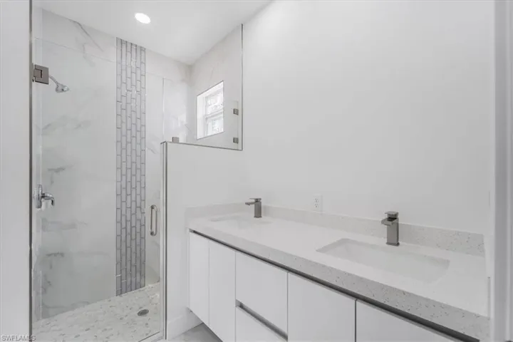 Bathroom with vanity and a shower with door