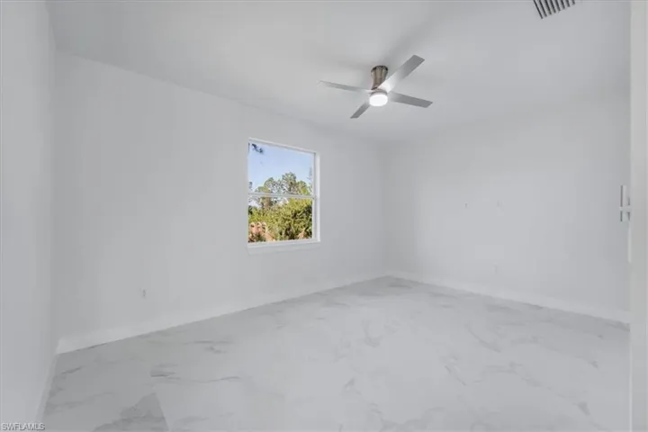 Unfurnished room featuring ceiling fan