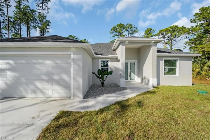 View of front facade with a front yard and a garage