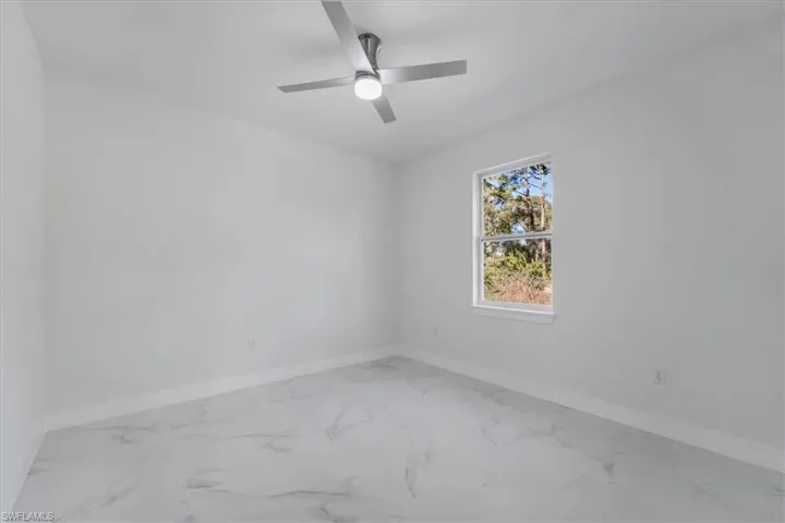 Unfurnished room featuring ceiling fan